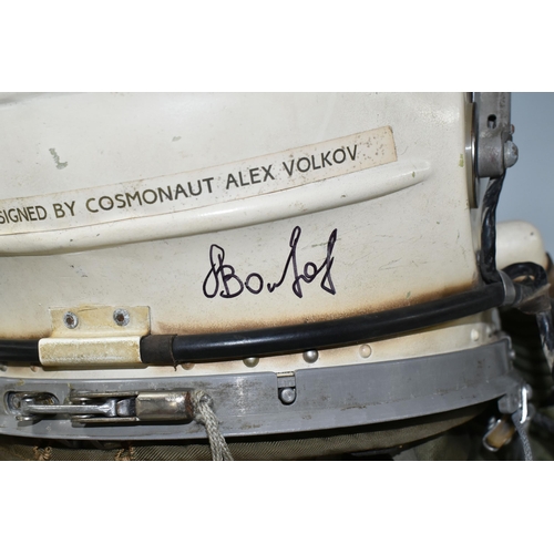 362 - A RUSSIAN MIG PILOTS FLYING SUIT AND HELMET, the helmet is signed by the pilot Alex Volkov, he went ... 