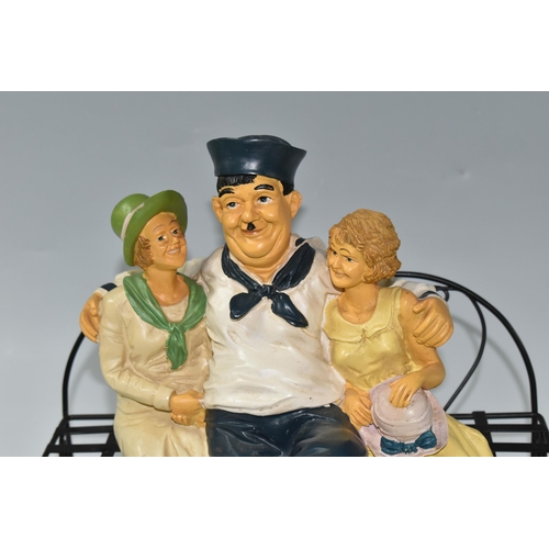 366 - A VINTAGE COMPOSITE RESIN FIGURE OF LAUREL AND HARDY as sailors on a bench with two women, (2) (Cond... 