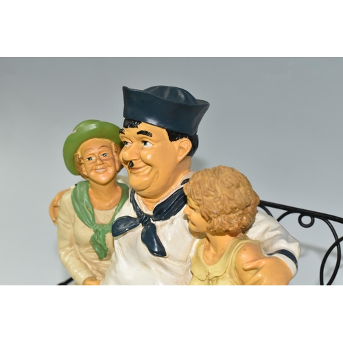 366 - A VINTAGE COMPOSITE RESIN FIGURE OF LAUREL AND HARDY as sailors on a bench with two women, (2) (Cond... 