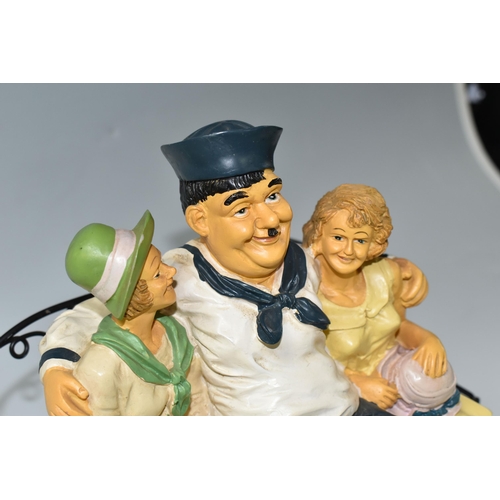 366 - A VINTAGE COMPOSITE RESIN FIGURE OF LAUREL AND HARDY as sailors on a bench with two women, (2) (Cond... 