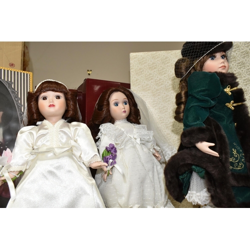 378 - A GROUP OF PORCELAIN DOLLS, comprising of four Franklin Heirloom dolls with boxes, one dressed in a ... 