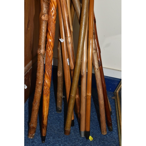 387 - A GROUP OF VINTAGE WALKING STICKS, comprising of approximately thirteen wooden novelty canes/swagger... 