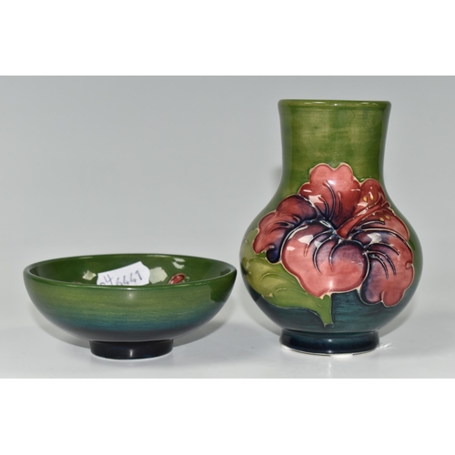 401 - TWO PIECES OF MOORCROFT POTTERY, comprising a small baluster vase in Hibiscus pattern on a green-blu... 