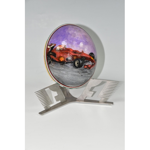 455 - A BOXED HANDPAINTED OSTRICH EGG, decorated with Ferrari emblem and F1 racing car, supported by a met... 