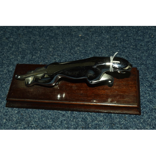 493 - A CHROMED LEAPING JAGUAR MASCOT MOUNTED ON A WOODEN PLINTH, Jaguar marked Regd. Desn. to underside, ... 