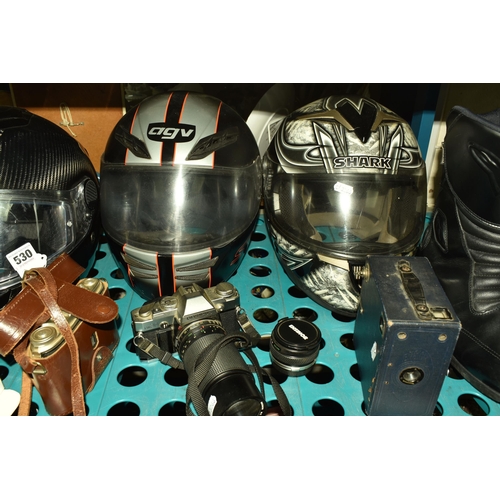 530 - A LARGE QUANTITY OF MOTORCYCLE WEAR, VINTAGE CAMERAS, ETC to include seven helmets comprising three ... 