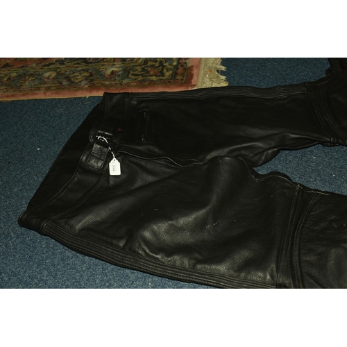 553 - A SET OF MEN'S MOTORBIKE LEATHERS, comprising a pair of 'TT Leathers' black leather trousers, UK siz... 