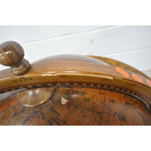 1202 - A 20TH CENTURY DRINKS GLOBE, the hinged lid enclosing a fitted interior, raised on turned supports, ... 