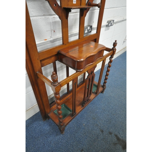 1203 - A 20TH CENTURY MAHOGANY HALL STAND, with a central bevelled edge mirror, seven pegs, three hooks, a ... 