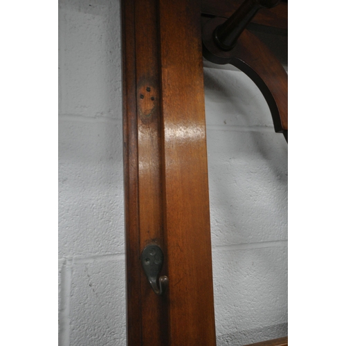 1203 - A 20TH CENTURY MAHOGANY HALL STAND, with a central bevelled edge mirror, seven pegs, three hooks, a ... 