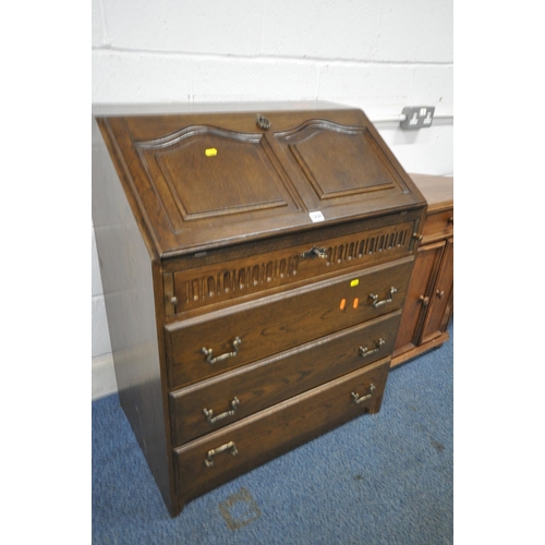 1204 - A 20TH CENTURY OAK BUREAU, the fall front door enclosing a fitted interior, above four drawers, widt... 