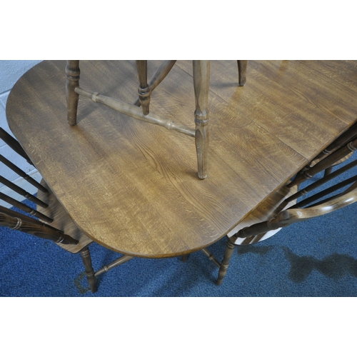 1207 - A MODERN DINETTE EXTENDING DINING TABLE, with a single fold out leaf, raised on turned legs, extende... 