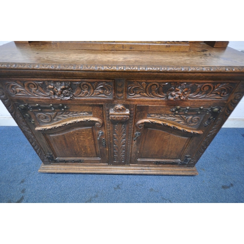 1208 - A 20TH CENTURY OAK MIRROR BACK SIDEBOARD, with a foliate crest and carved details, the central bevel... 