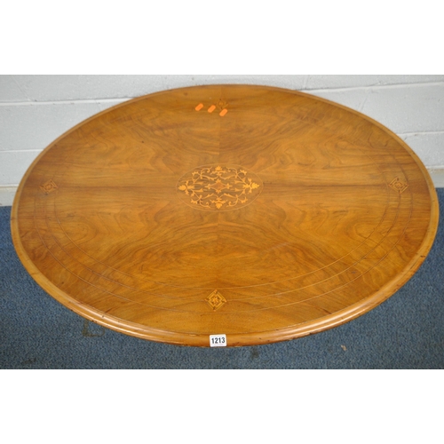 1213 - A VICTORIAN WALNUT OVAL TILT TOP TABLE, raised on turned supports, and four legs, united by a centra... 