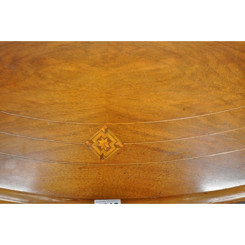 1213 - A VICTORIAN WALNUT OVAL TILT TOP TABLE, raised on turned supports, and four legs, united by a centra... 