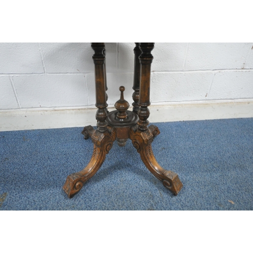 1213 - A VICTORIAN WALNUT OVAL TILT TOP TABLE, raised on turned supports, and four legs, united by a centra... 