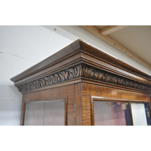 1214 - A WILLIAM AND MARY STYLE WALNUT DISPLAY, the double glazed doors enclosing two glass shelves, atop a... 