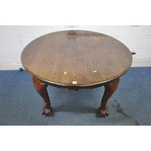 1216 - A VICTORIAN MAHOGANY WIND OUT DINING TABLE, with three additional leaves, raised on cabriole legs, w... 