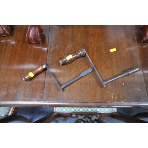 1216 - A VICTORIAN MAHOGANY WIND OUT DINING TABLE, with three additional leaves, raised on cabriole legs, w... 