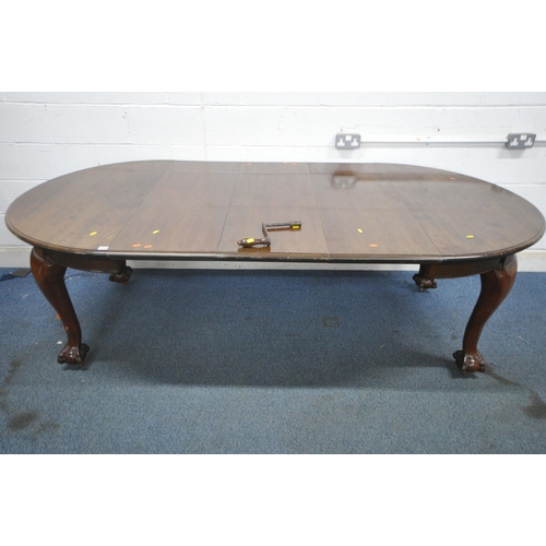 1216 - A VICTORIAN MAHOGANY WIND OUT DINING TABLE, with three additional leaves, raised on cabriole legs, w... 