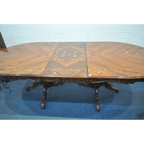 1241 - A REPRODUCTION OVAL EXTENDING DINING TABLE, with a single fold out leaf, raised on twin bulbous supp... 