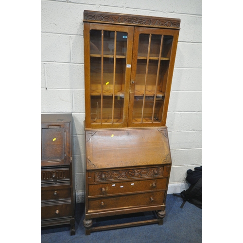 1244 - A 20TH CENTURY OAK BUREAU BOOKCASE, the double glazed door enclosing two shelves, atop a base with a... 