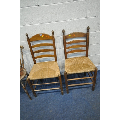 1251 - TWO 20TH CENTURY OAK LADDER BACK CHAIRS, with rush seats, a chair with a circular seat, along with a... 