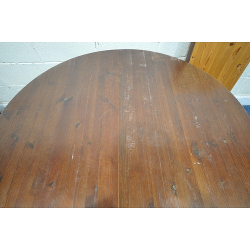 1264 - A PINE CIRCULAR EXTENDING DINING TABLE, with two additional leaves, extended length 200cm x diameter... 