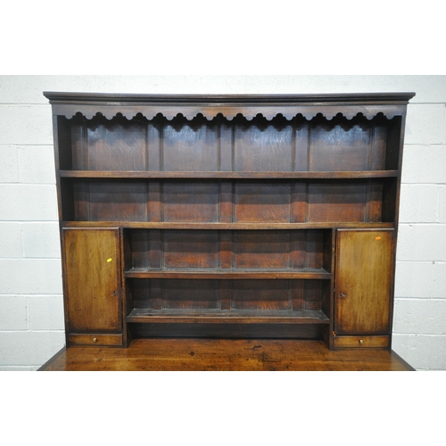 1288 - A GEORGIAN AND LATER OAK DRESSER, the later five tier plate rack with two cupboard doors, and two dr... 