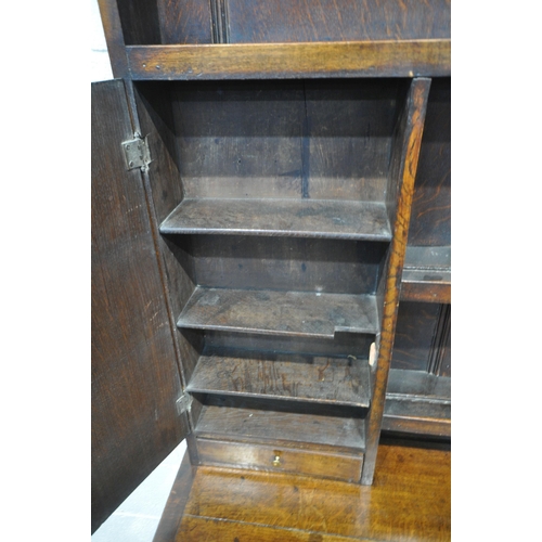 1288 - A GEORGIAN AND LATER OAK DRESSER, the later five tier plate rack with two cupboard doors, and two dr... 