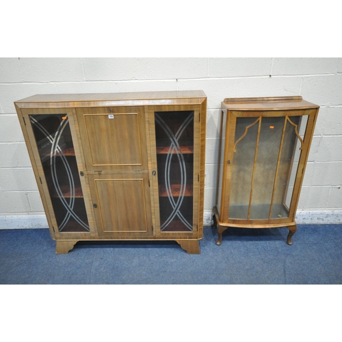 1292 - A 20TH CENTURY CABINET, with two glass doors, flanking a fall front door, that's enclosing a fitted ... 