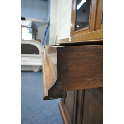 1296 - A VICTORIAN MAHOGANY BOOKCASE, the double glazed doors enclosing three shelves, atop a base with a s... 