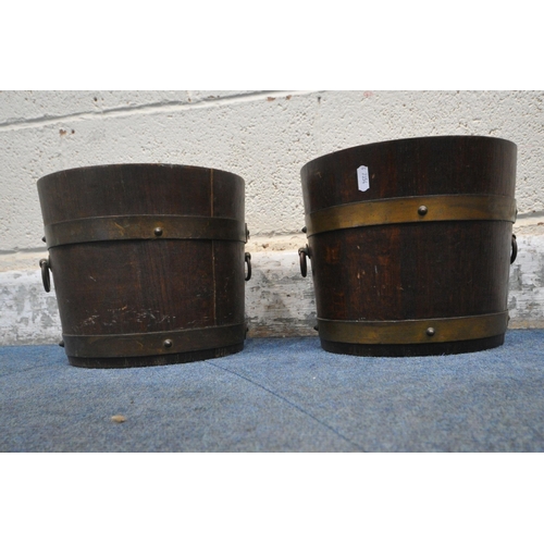 1297 - R.A.LISTER AND CO, DURSLEY, ENGLAND, A PAIR OF SMALL OAK AND BRASS BANDED BARRELS, with twin metal h... 