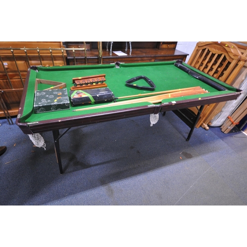 1317 - A SLATE BED FOLDING POOL TABLE, with a boxed snooker / billiards set, a set of pool balls, two ball ... 