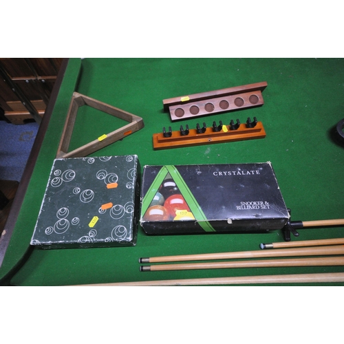 1317 - A SLATE BED FOLDING POOL TABLE, with a boxed snooker / billiards set, a set of pool balls, two ball ... 