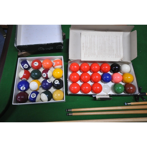 1317 - A SLATE BED FOLDING POOL TABLE, with a boxed snooker / billiards set, a set of pool balls, two ball ... 