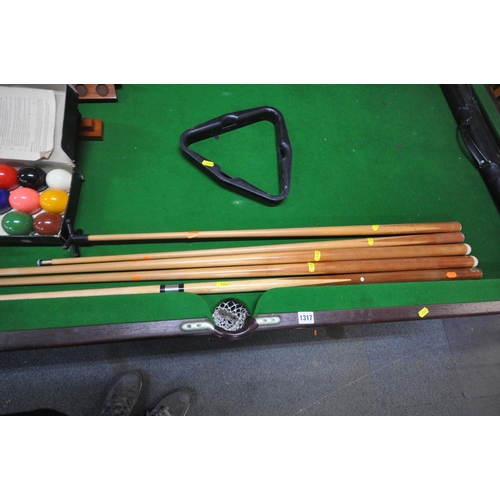 1317 - A SLATE BED FOLDING POOL TABLE, with a boxed snooker / billiards set, a set of pool balls, two ball ... 