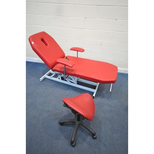 1322 - A RED LEATHERETTE ELECTRIC RISE AND FALL MASSAGE BED, with adjustable mechanisms, along with a stool... 