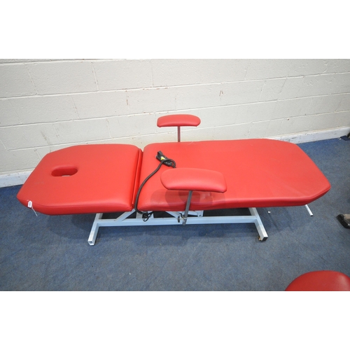 1322 - A RED LEATHERETTE ELECTRIC RISE AND FALL MASSAGE BED, with adjustable mechanisms, along with a stool... 