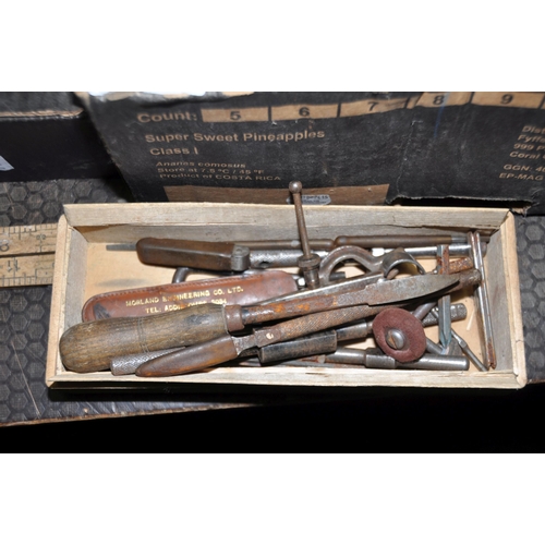 1057 - FOUR TRAYS CONTAINING VINTAGE TOOLS including thread gauges, tap holders, pick axe heads, secateurs,... 