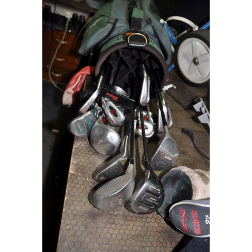 1115 - A GOLF BAG CONTAINING CLUBS AND TWO TROLLEYS including Ben Sayer irons and PMG2 woods