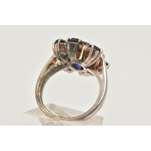 13 - A SAPPHIRE AND DIAMOND DRESS RING, designed as a central oval sapphire flanked by two single cut dia... 