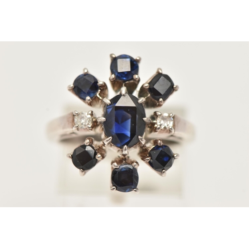 13 - A SAPPHIRE AND DIAMOND DRESS RING, designed as a central oval sapphire flanked by two single cut dia... 