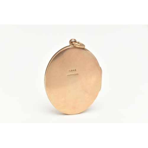 20 - A 9CT GOLD LOCKET, designed as an oval with scrolling acanthus detail to the front, approximate leng... 