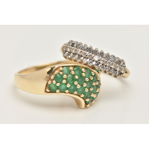 31 - TWO GEM SET RINGS, the first a cross over yellow gold ring pave set with twenty four circular cut em... 