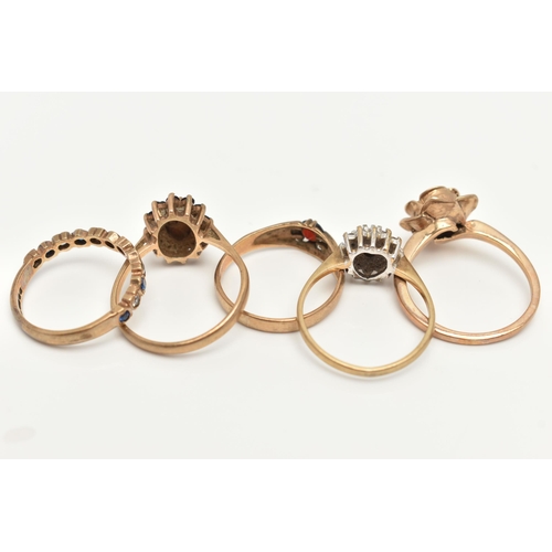 33 - FOUR 9CT GOLD RINGS AND A YELLOW METAL RING, the first a yellow gold floral ring, ring size M 1/2, a... 