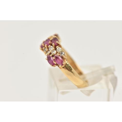 41 - AN 18CT GOLD RUBY AND DIAMOND RING, set with seven oval cut rubies and small round brilliant cut dia... 