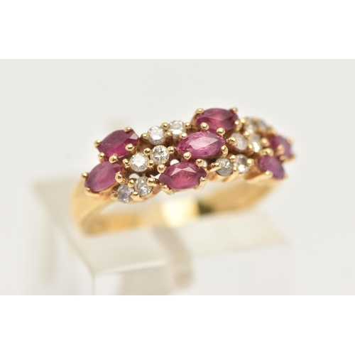 41 - AN 18CT GOLD RUBY AND DIAMOND RING, set with seven oval cut rubies and small round brilliant cut dia... 