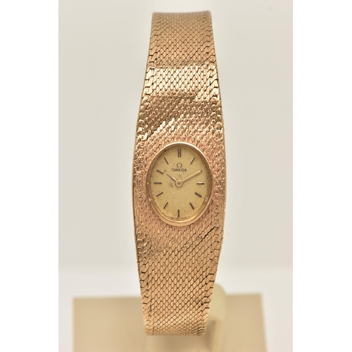 47 - A LADY'S OMEGA 9CT GOLD WRISTWATCH, the oval gold coloured face with baton markers to the mesh brace... 