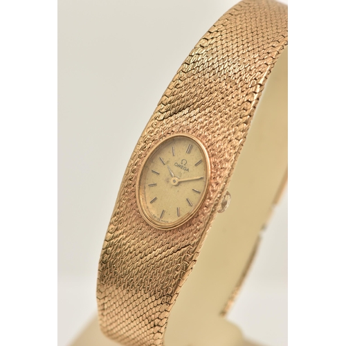 47 - A LADY'S OMEGA 9CT GOLD WRISTWATCH, the oval gold coloured face with baton markers to the mesh brace... 